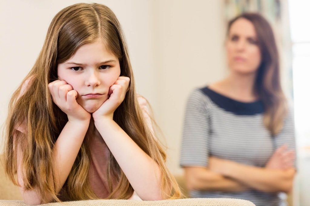 daughter-sitting-upset-with-her-mother-living-room